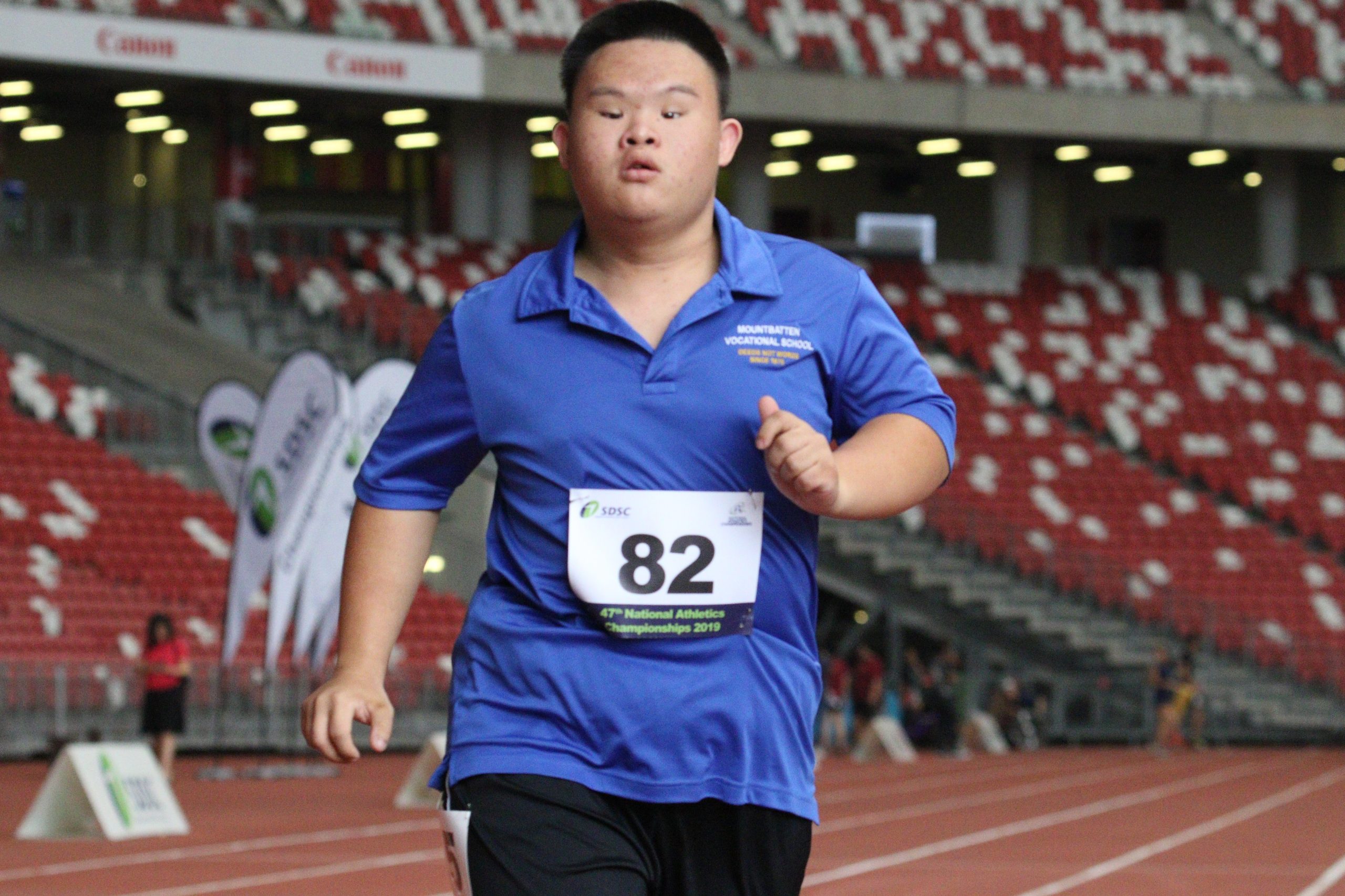Jason Gan runs to the finishing line in the Men's II2 100m