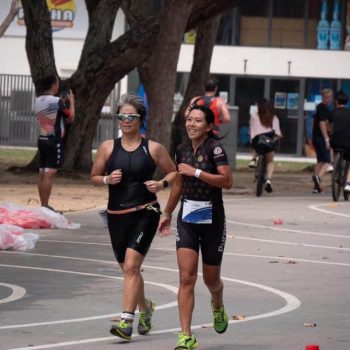 Delia Kang (left) running with her triathlon guide Jaynelle Lee (right)